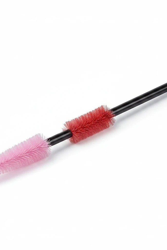 Carmon's Quilt Shop The Gypsy Quilter cleaning tool with pink and red silicone bristles on a black handle
