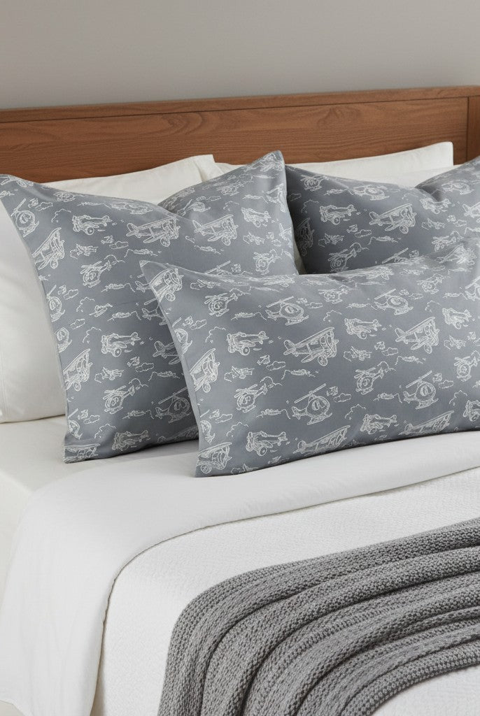 Carmon's Quilt Shop Soaring Dreams Teal 100% Cotton fabric with white line drawings of airplanes and helicopters on a gray-blue background.