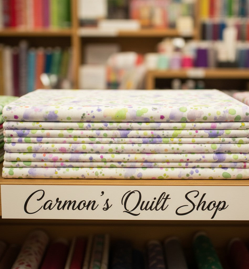 Carmon's Quilt Shop Sally's Speckle paint splatter 108-inch wide cotton backing fabric folded on a store shelf.