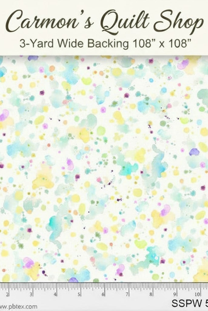 Carmon's Quilt Shop 108-inch wide cotton fabric featuring a colorful paint splatter design on a white background.