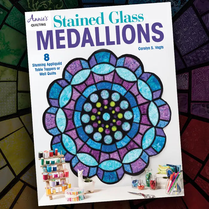 Carmon's Quilt Shop Stained Glass Medallions pattern book cover featuring a vibrant purple and blue appliqué quilt