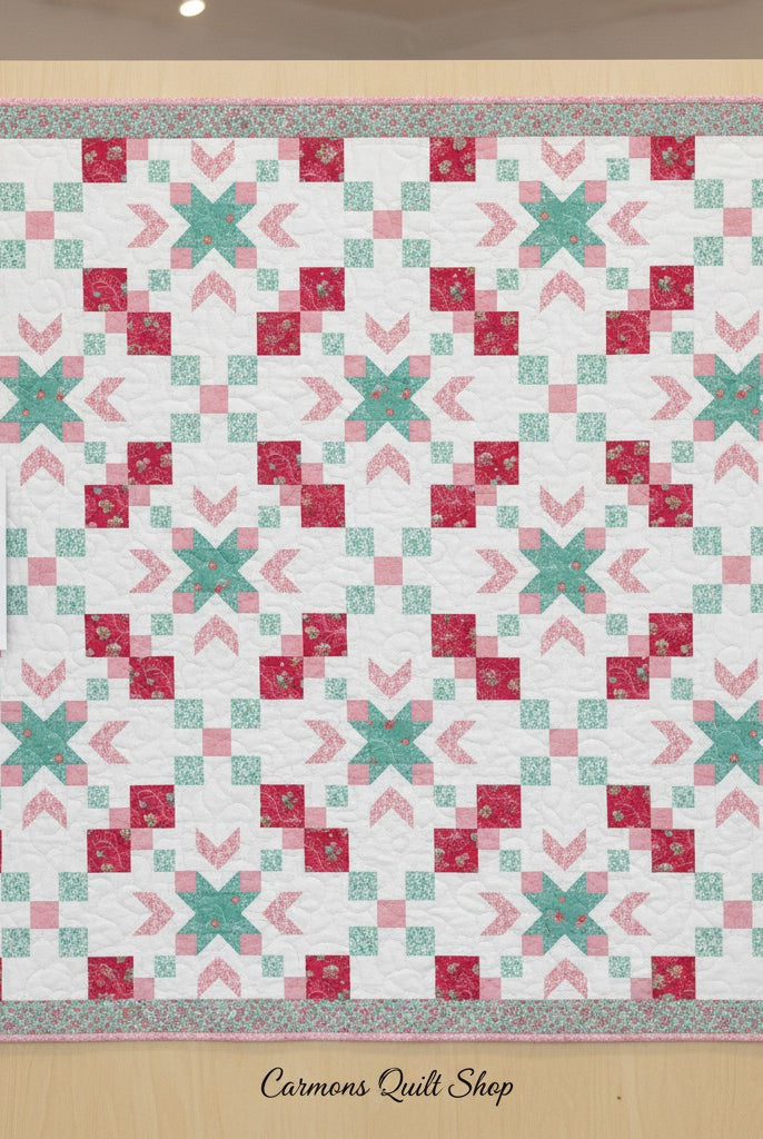 Carmon's Quilt Shop Starry-Eyed quilt kit featuring floral 100% cotton fabric in pink, teal, and white patterns.