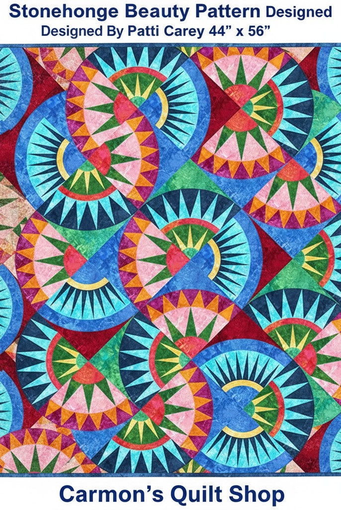 Carmon's Quilt Shop Stonehenge Beauty quilt featuring a vibrant paper-pieced star pattern in blue, red, and green tones.