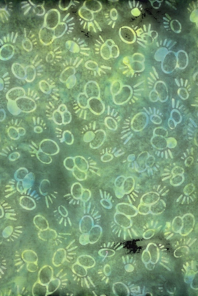 Carmon's Quilt Shop Vintner's Treasure Island Batik fabric in green and purple with a whimsical circular pattern.