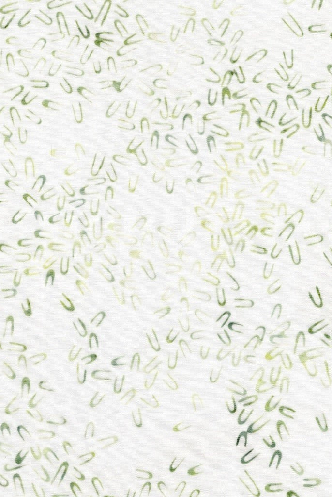 Carmon's Quilt Shop Vintner's Treasure batik fabric featuring a white background with small green U-shaped motifs.