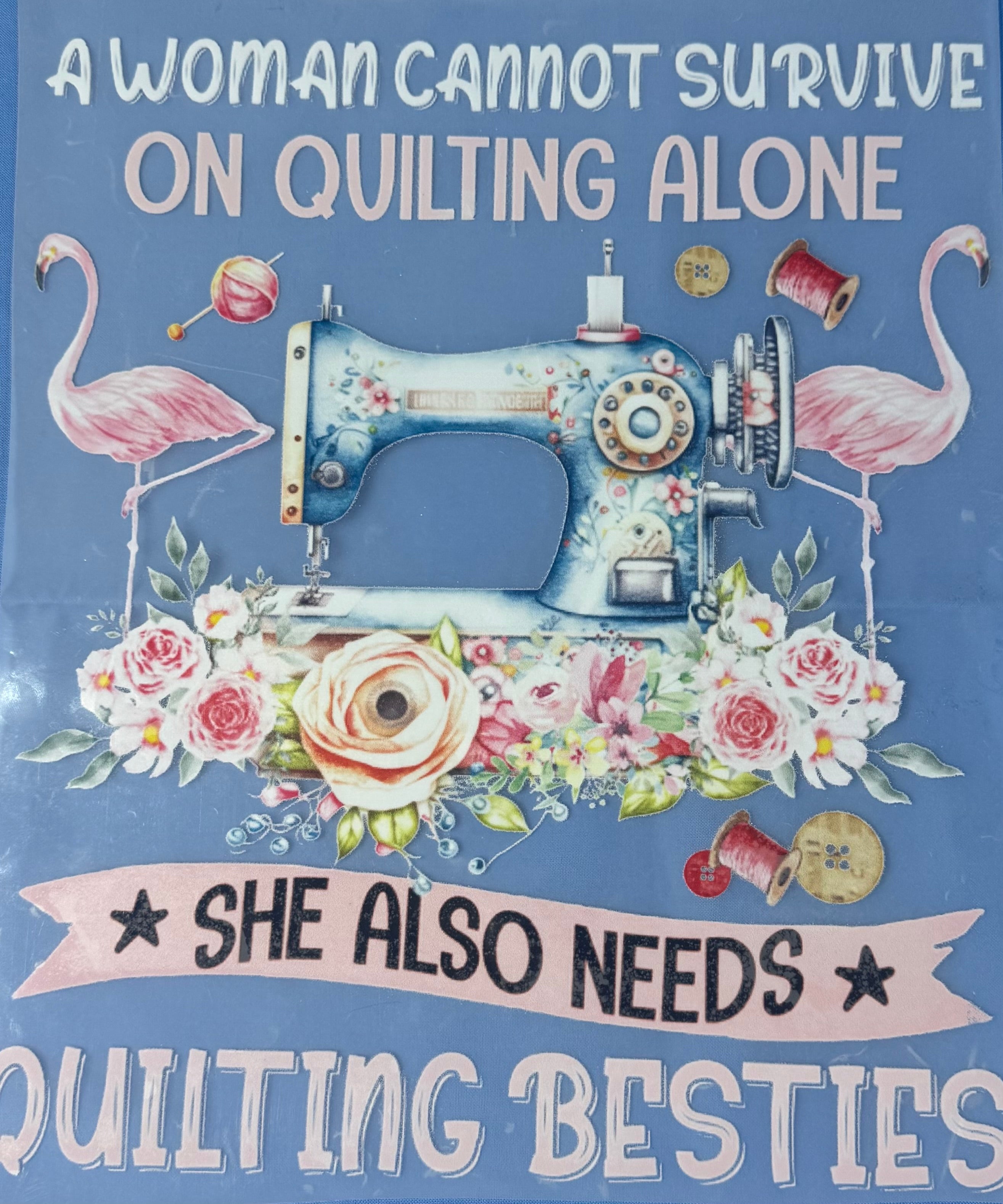Decorative sign with sewing machine, flamingos, and floral elements on a blue background with text.
