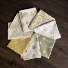 Collection of patterned fabric squares on a wooden surface