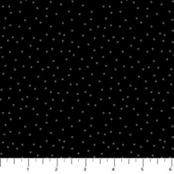 Black fabric with white polka dots and a ruler at the bottom