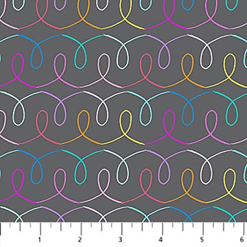 Colorful wavy line pattern on gray fabric with a ruler at the bottom.