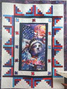 Quilt with a central portrait surrounded by decorative borders featuring stars and stripes. Building Quilts With Panels Pattern Book - 4th & Main Designs- Carmon's Quilt Shop 