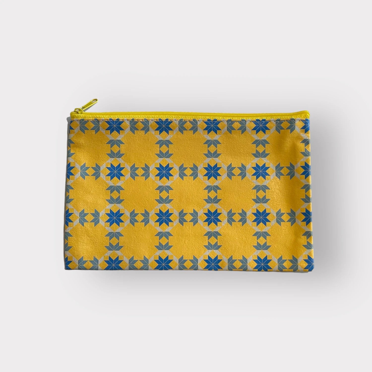 Yellow pouch with blue star pattern on a white background