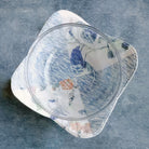 Glass bowl with floral pattern on a textured blue surface Color Blocked Bowl Cozy -Size 13" x 13"  Designed By Carolina Moore - Carmon's Quilt Shop