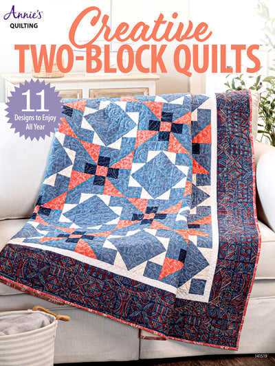 Quilt with two-block pattern on a couch, featuring Annie's Quilting branding.