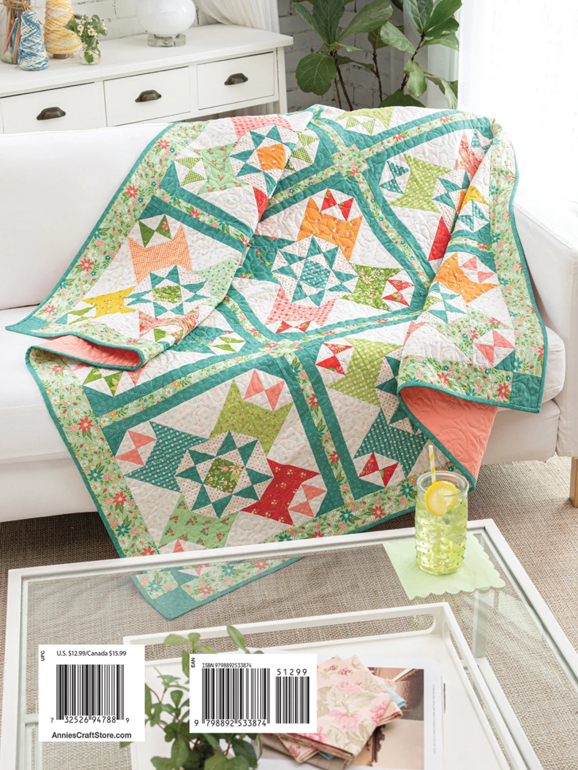 Colorful quilt with star patterns draped over a couch in a living room setting.  Daydream Sampler Quilt Pattern Book  # 141541 - Annie's Quilting- Carmon's Quilt Shop