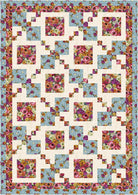 Floral quilt with a geometric pattern on a blue background
