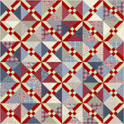 Quilt with red, blue, and beige geometric patterns. Granny’s Secret Quilt Pattern Designed by Glenda Wilder Designs - Carmon's Quilt Shop