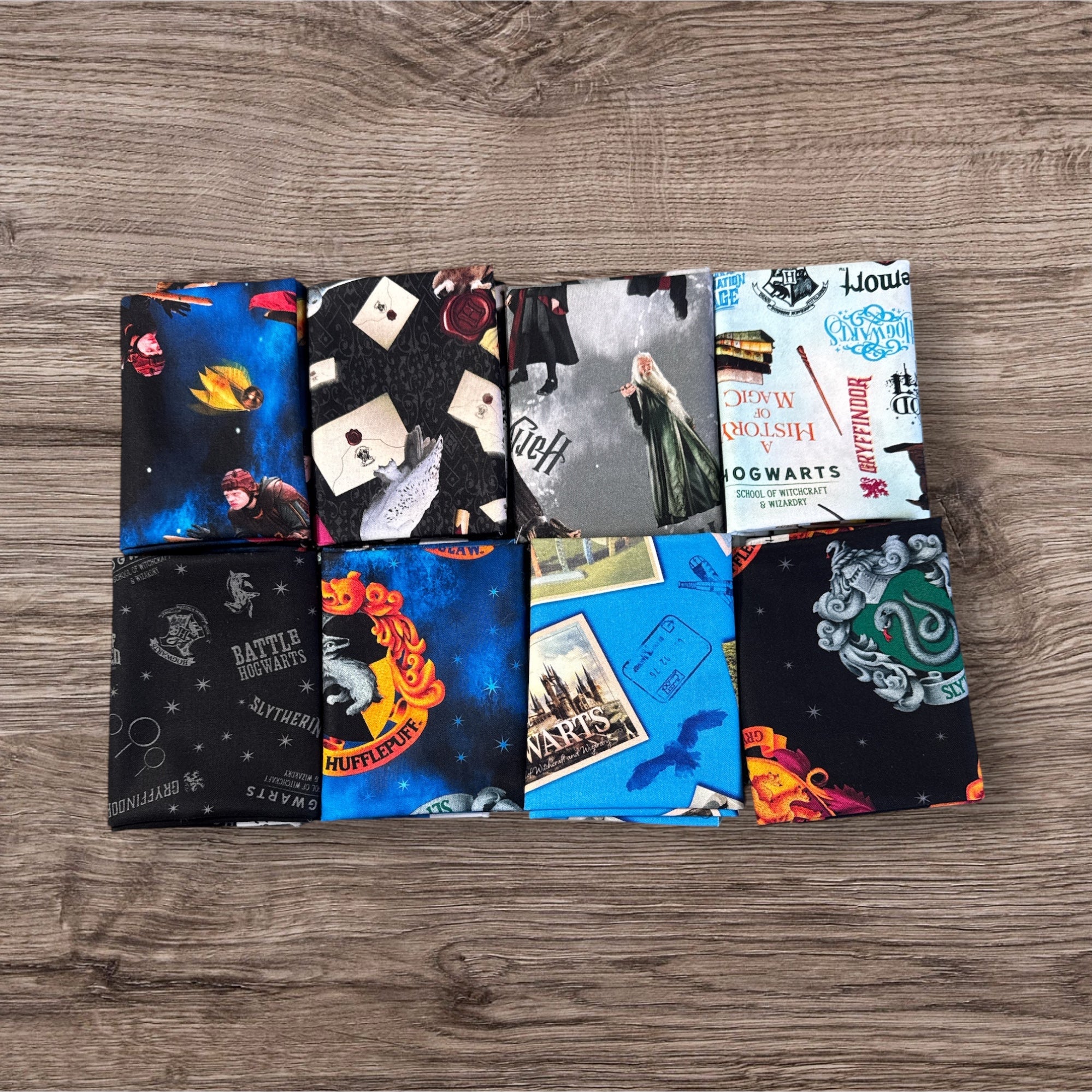 Collection of themed fabric swatches on a wooden surface