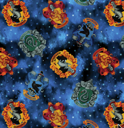 Pattern of Hogwarts house crests on a blue starry background Harry Potter House Crests Blue. Benartex Fabric Carmon's Quilt Shop