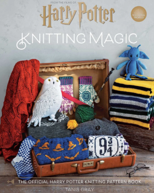 Book cover of 'Knitting Magic' featuring knitted items and a owl on a wooden surface.