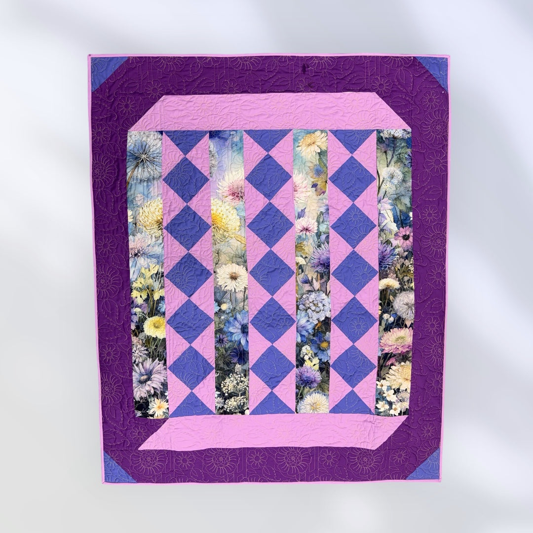 Quilt with purple and pink diamond pattern and floral inset on a white  Lovely Flowers Quilt Kit Finished Size - Northcott/Timeless Treasures Fabric 49.75" x 60" -Carmons Quilt Shopbackground