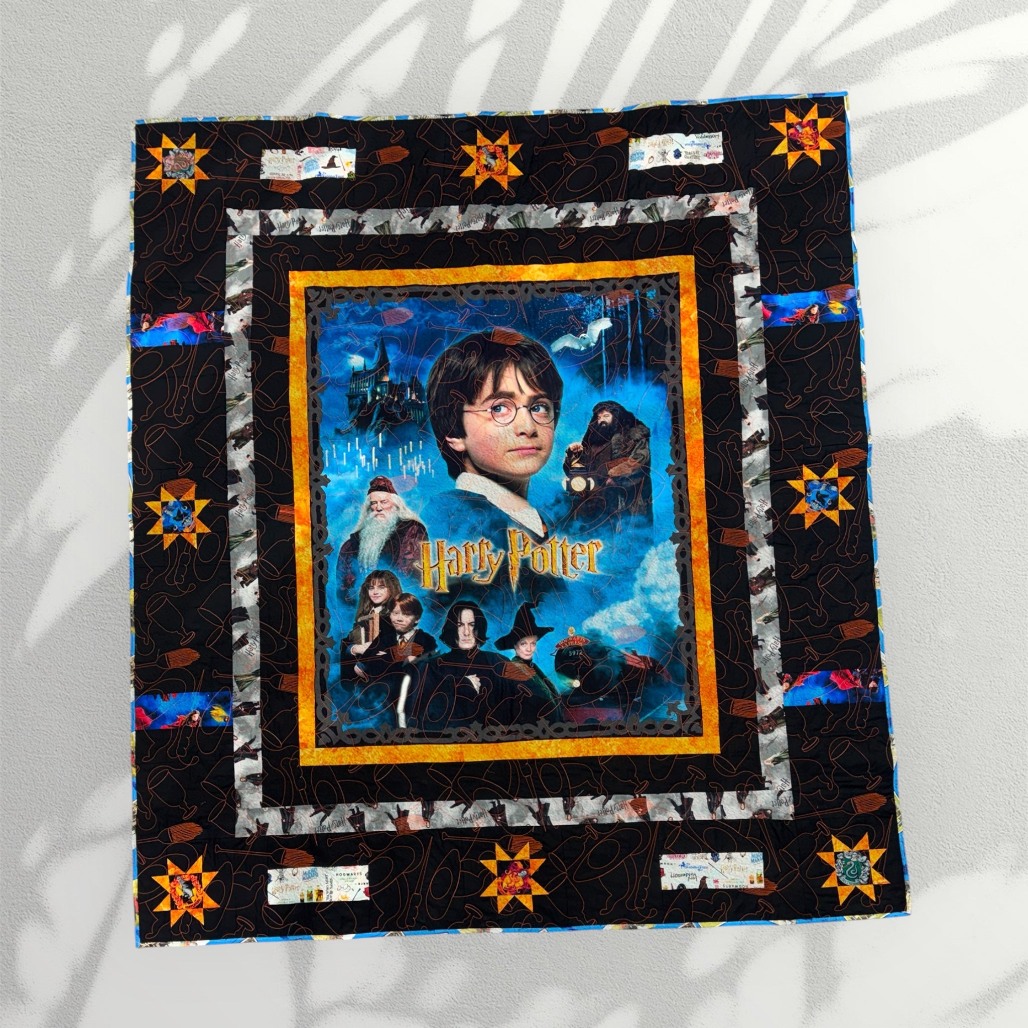 Harry Potter-themed quilt with characters and scenes from the series on a white background