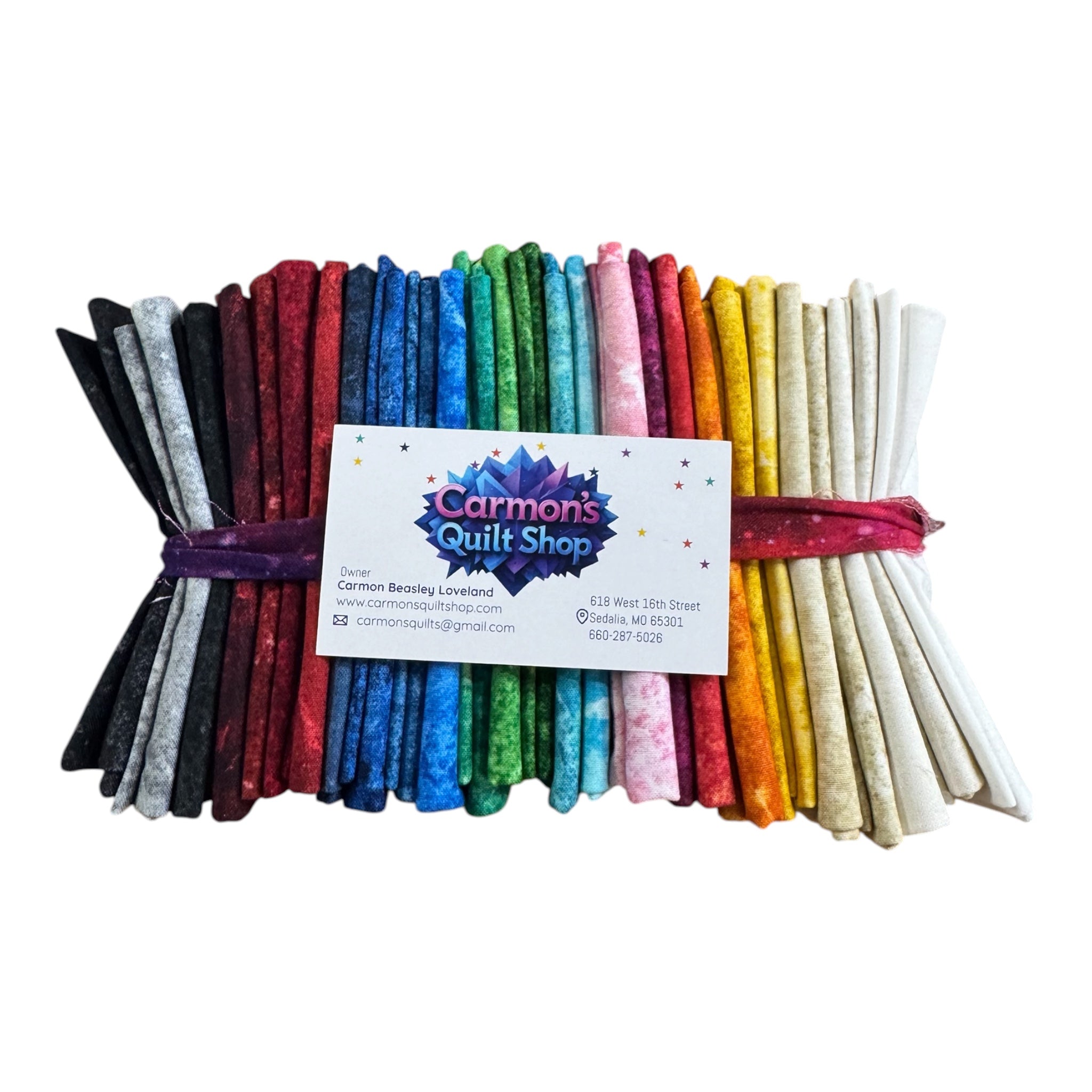 Bundle of colorful fabric strips with a business card on a white  Stonehenge Basics 28 Fat Quarter Bundle Northcott Carmon's Quilt Shop