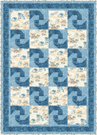 Quilt with a blue and beige pattern featuring fish and shell designs.