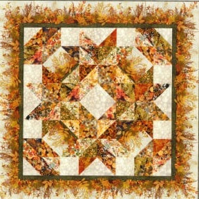 A quilt pattern named Reflections of Autumn Wreath Wall Hanging, featuring geometric star patterns in shades of orange, yellow, and brown.