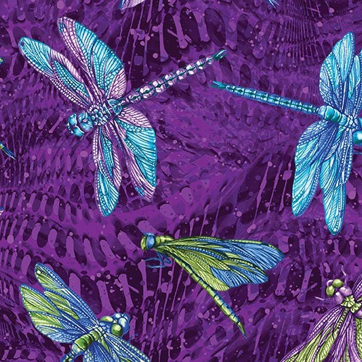 Carmon's Quilt Shop Dragonfly Wonder cotton fabric featuring vibrant blue and green dragonflies on a purple background