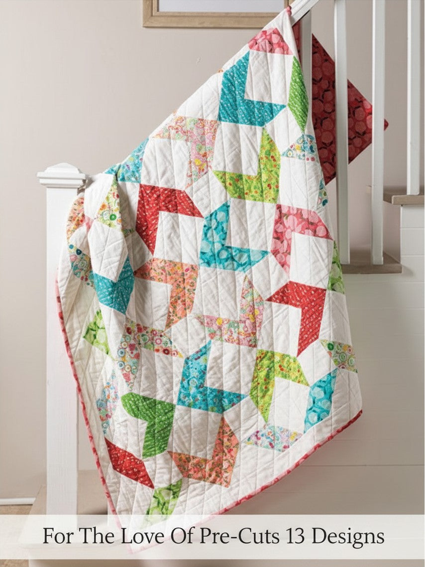 Carmon's Quilt Shop For the Love of Precuts pattern book featuring a colorful geometric quilt draped on a railing