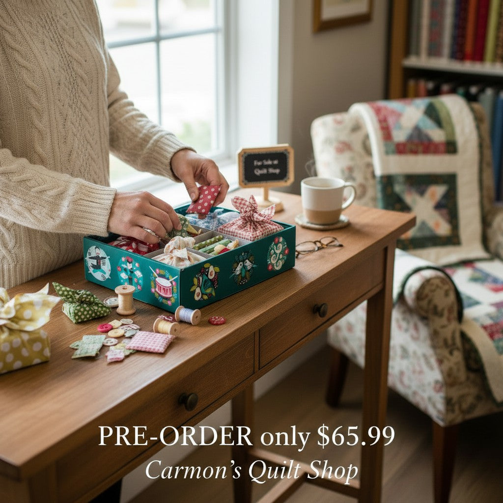 Carmon's Quilt Shop Twelve Days of Christmas advent box with fabric bundles and sewing notions on a wooden table.