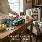 Carmon's Quilt Shop Twelve Days of Christmas advent box with fabric bundles and sewing notions on a wooden table.