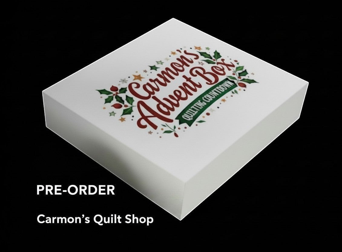 Carmon's Quilt Shop limited-edition premium quilter's advent box with festive holiday branding on a white gift box.