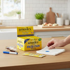 Carmon's Quilt Shop Amodex ink and stain remover trial pack display box with individual sachets on a kitchen counter