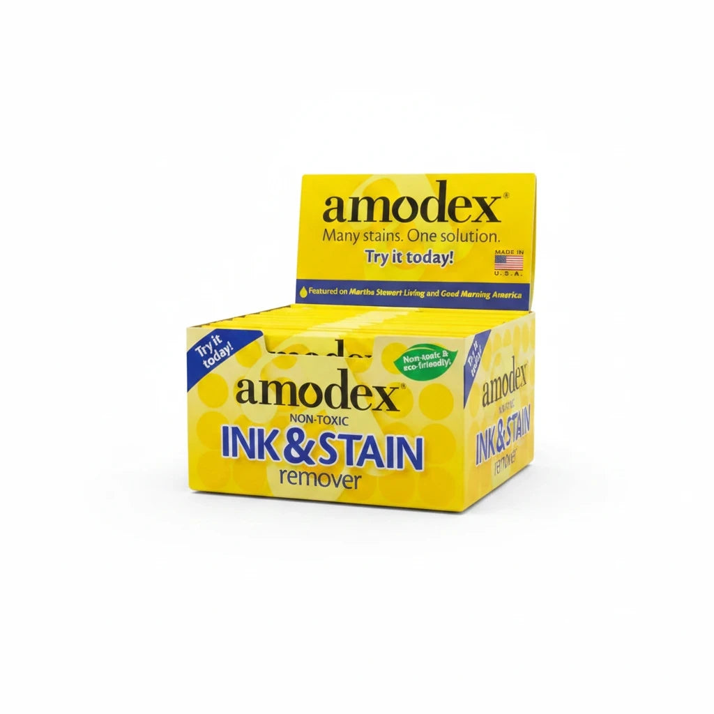 Carmon's Quilt Shop Amodex ink and stain remover trial pack in a yellow display box for fabrics and surfaces