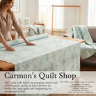 Carmon's Quilt Shop light aqua mottled texture 118 inch wide cotton quilting fabric draped over a wooden table