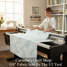 Carmon's Quilt Shop light aqua mottled texture 118 inch wide cotton quilting fabric on a longarm machine