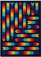 Carmon's Quilt Shop Arrowdynamic quilt kit featuring a vibrant rainbow arrow pattern on a dark background