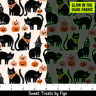 Carmon's Quilt Shop FIGO Fabrics black cotton quilting fabric featuring a glow-in-the-dark cat and pumpkin pattern.