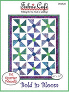 Carmon's Quilt Shop Fabric Café Bold in Bloom quilt pattern featuring a vibrant pinwheel design in blue and green.