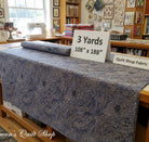 Carmon's Quilt Shop Meadow Breeze brown floral 108-inch wide cotton quilt backing fabric on a cutting table