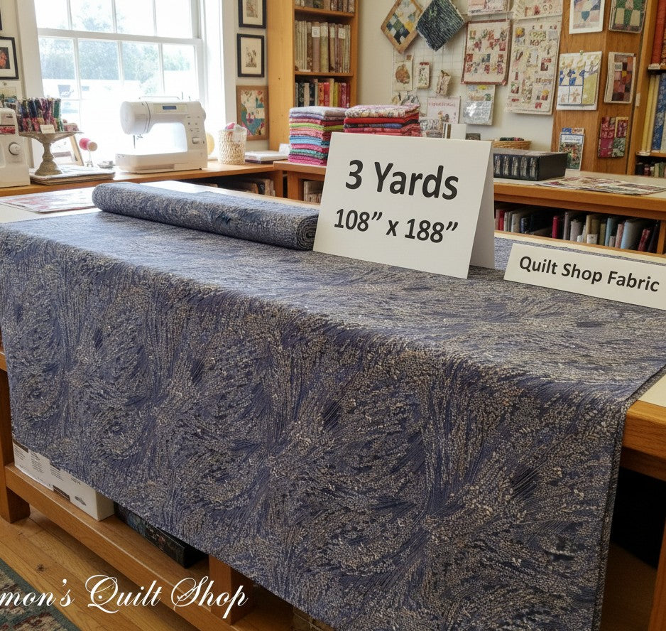 Carmon's Quilt Shop Meadow Breeze brown floral 108-inch wide cotton quilt backing fabric on a cutting table
