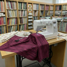 Carmon's Quilt Shop burgundy wood textured abstract cotton fabric on a sewing machine in a fabric store