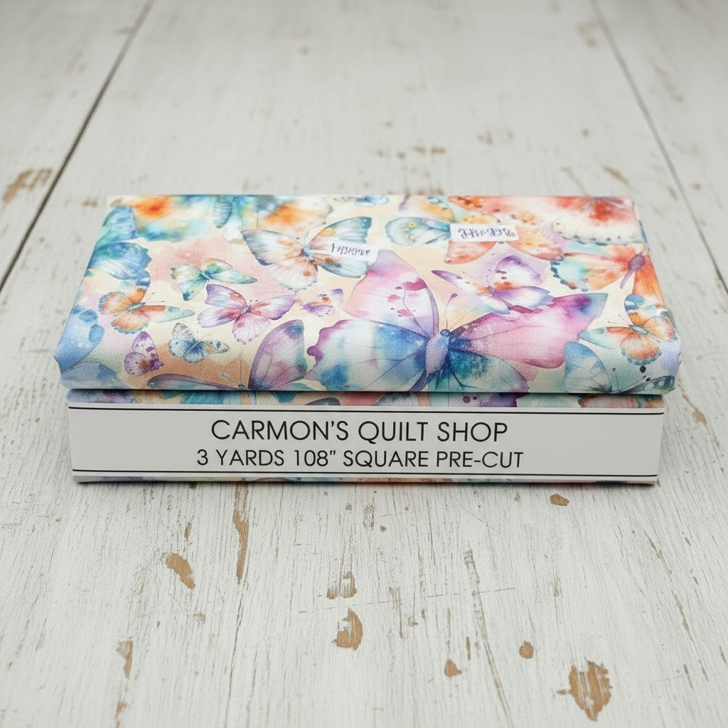 Carmon's Quilt Shop Butterfly Wishes cream cotton fabric 108-inch wide quilt backing with colorful butterfly print.