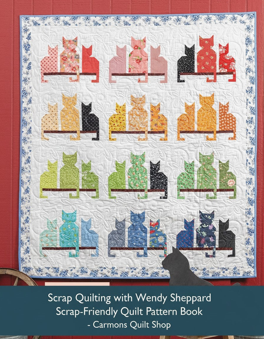 Carmon's Quilt Shop scrap quilt featuring colorful cat silhouettes on a white floral background