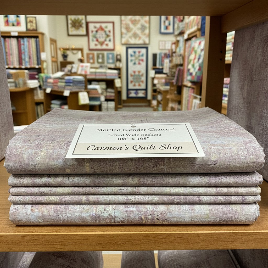 Carmon's Quilt Shop charcoal mottled blender 100% cotton wide quilt backing fabric folded on a store shelf