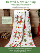 Carmon's Quilt Shop Christmas quilt featuring star and tree patterns in red, green, and white fabric on a wooden bench.