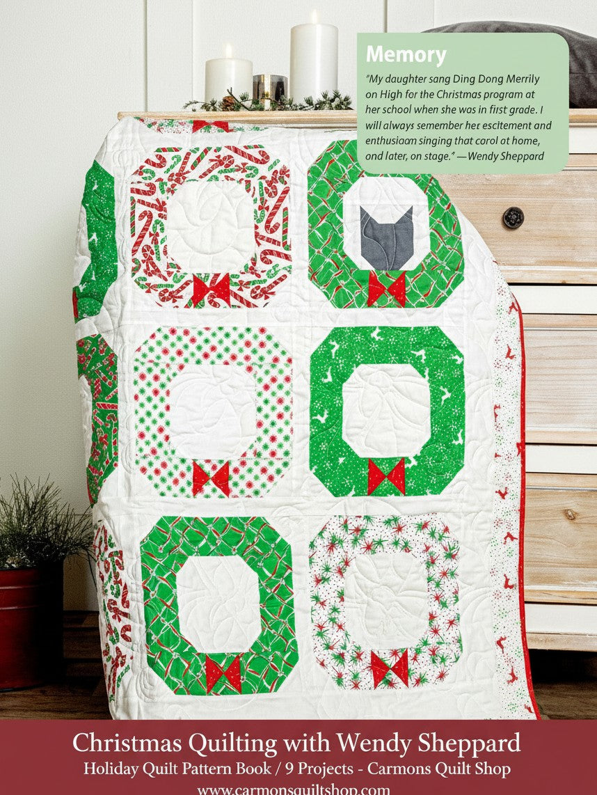 Carmon's Quilt Shop Christmas quilt featuring festive wreath blocks with candy cane and holly patterns on a dresser