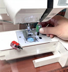 Carmon's Quilt Shop compact screwdriver set being used on a sewing machine needle plate for maintenance