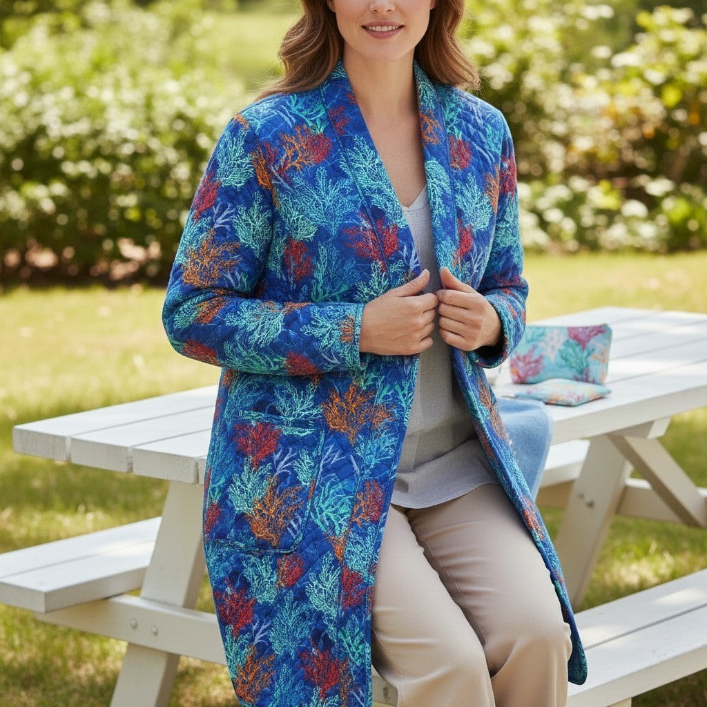 Carmon's Quilt Shop quilted jacket made from Oceana Coral fabric featuring orange and blue coral reef patterns.